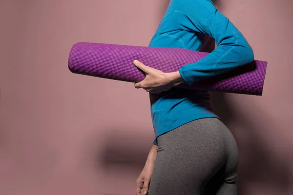 Sporty yoga girl with yoga mat wearing warm clothes for autumn working out, toned image