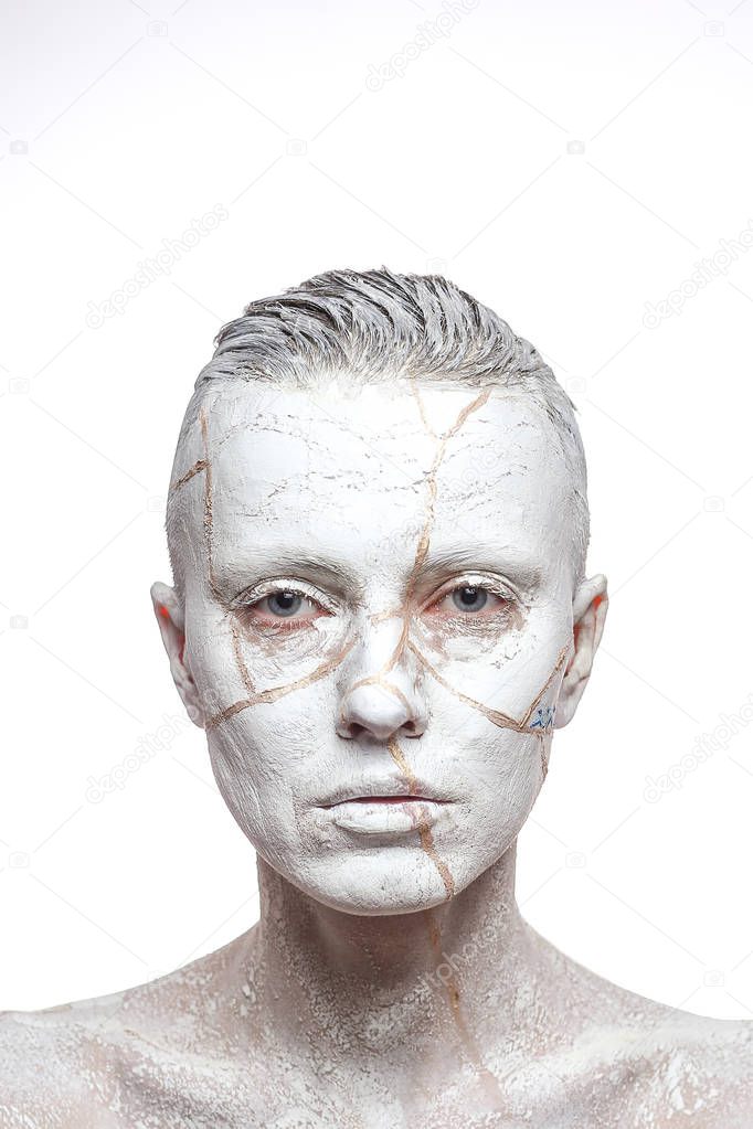 Beautiful woman with white clay on face.  Art portrait