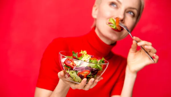 Schöne Kaukasische Frau Isst Salat Über Rotem Hintergrund — Stockfoto