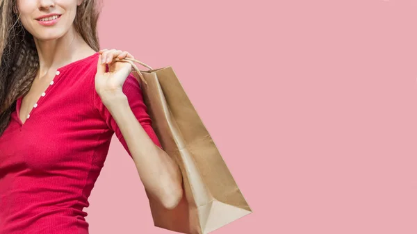 ピンクの背景の上にショッピングバッグを持つ白人のショッピングウーマン — ストック写真