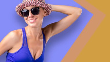 Parlak arka plan üzerinde şapka ve güneş gözlüğü güzel kadın