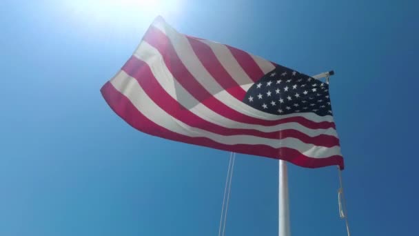Американский Флаг Размахивающий Ветру Перед Голубым Небом — стоковое видео