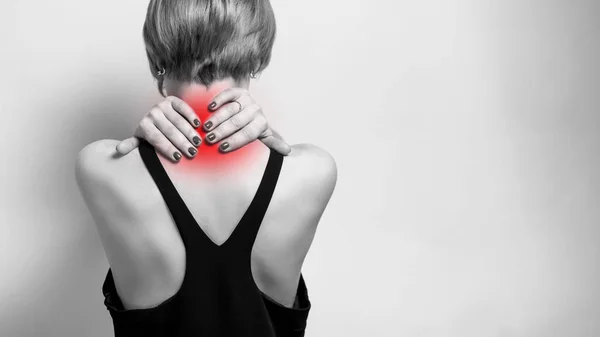 Young woman feeling exhausted and suffering from neck pain, painful area highlighted in red. Health concept — Stock Image Young Woman Feeling Exhausted Suffering Neck Pain Painful Area Highlighted Stock Photo