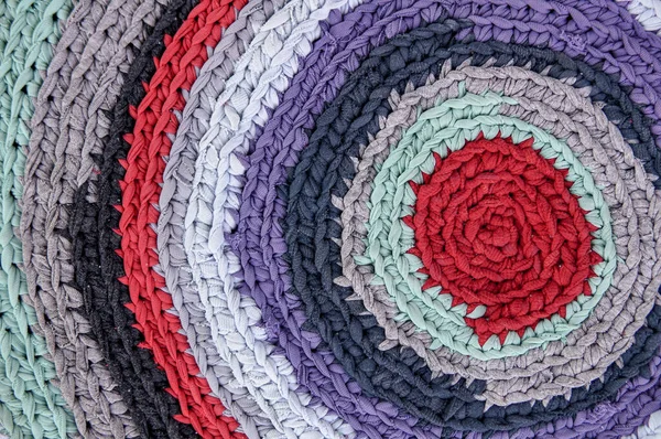 Colorful knitted carpet form used shirts, recycle concept