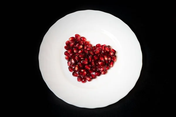 Pomegranate Seeds White Plate Heart Shape — Stock Photo, Image