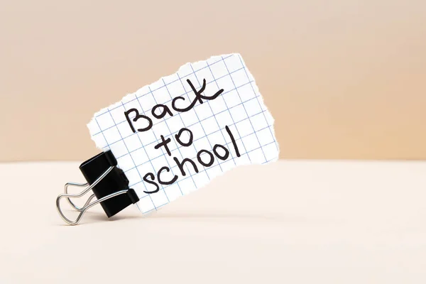 Back to school inscription on paper on beige background. — Stock Photo, Image