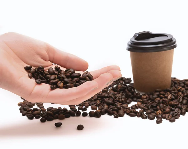 Coffee beans in female hand on white background — Stock Photo, Image