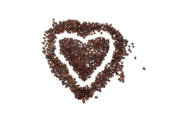 Κόκκοι καφέ σε σχήμα καρδιάς σε λευκό φόντο. — Φωτογραφία Αρχείου