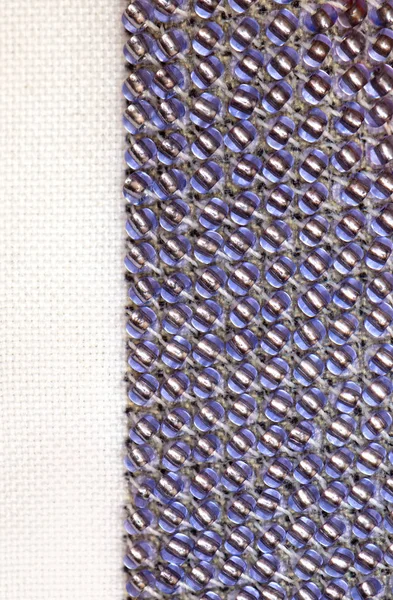Макро фото фіолетового бісероплетіння на полотні — стокове фото