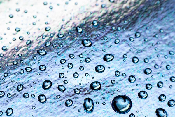 Gotas de água no fundo folha azul, close-up . — Fotografia de Stock