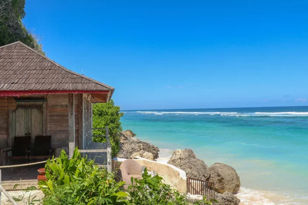 Tropical sea beach bungalow landscape. Beach bungalow on tropical beach scene. Tropical bungalow sand beach panorama.