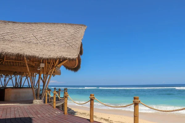 Music club and restaurant on Bali, Indonesia. Bamboo building with a reed roof on the sandy beach.