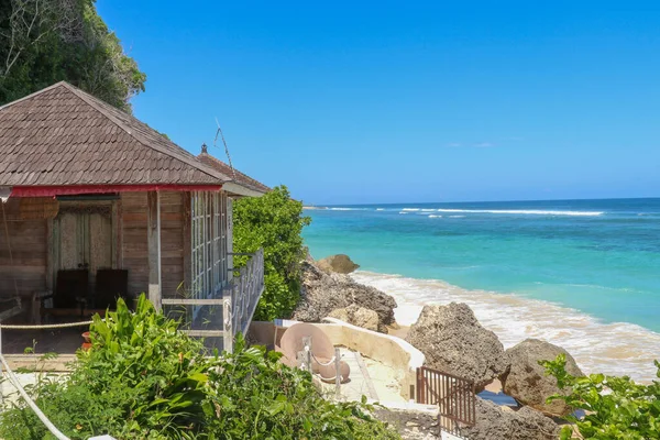 Tropical sea beach bungalow landscape. Beach bungalow on tropical beach scene. Tropical bungalow sand beach panorama.