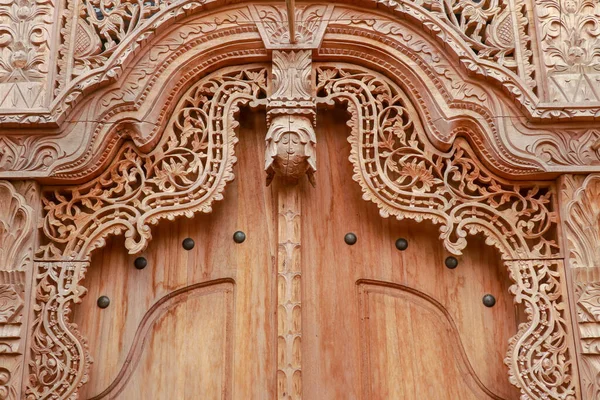 Balinese wood carved doors with traditional local ornaments. Local traditions and craftmanship concept