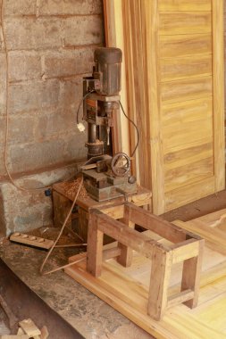 Tahtada metal bir matkapla bir ağaca delik açmak, el işi ve ahşap işçiliği teması..