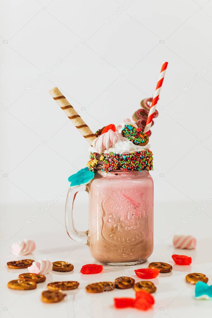 tasty milkshake with candies decorations close-up view