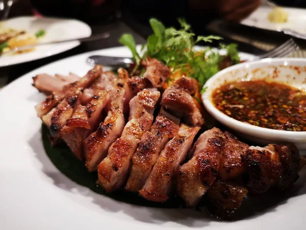 おいしいスライス タイ料理レストランで白い皿に豚のグリル — ストック写真