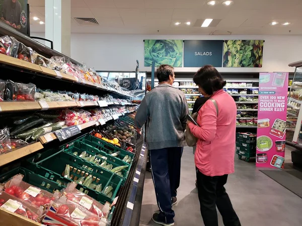 Londen, Uk - 7 oktober: Niet-geïdentificeerde Aziatische klant op zoek naar voedsel in supermarkt op 7 oktober 2019 in Londen, Uk. — Stockfoto