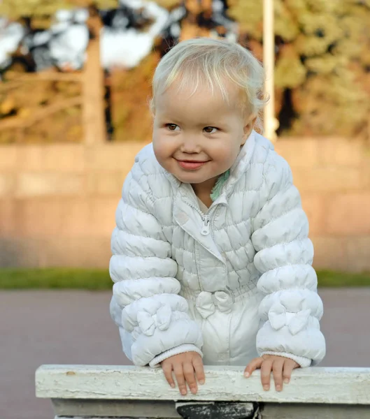 Portrait Little Smiling Happy Girl White Jacket Bench Walk Park — Stock Photo, Image