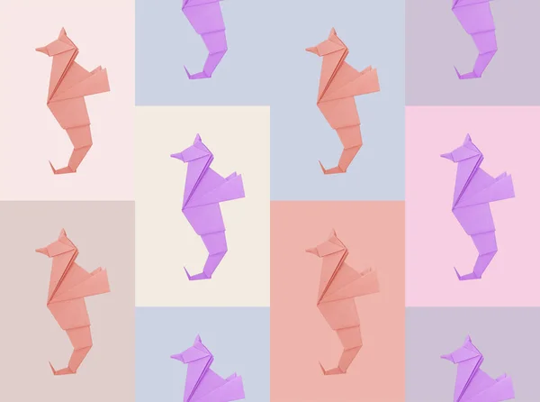 折纸海马在多色系彩绘背景图案上的应用 免版税图库照片