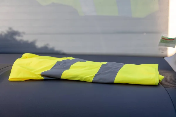 Yellow vest on a dashboard car in protest against tax increases in France