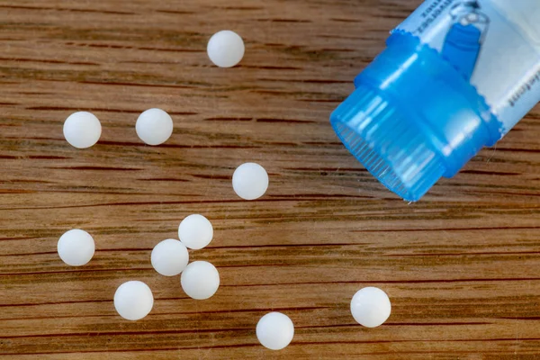 Homeopathic Globules Scattered Colored Containers Shape Tube Wooden Table — Stock Photo, Image