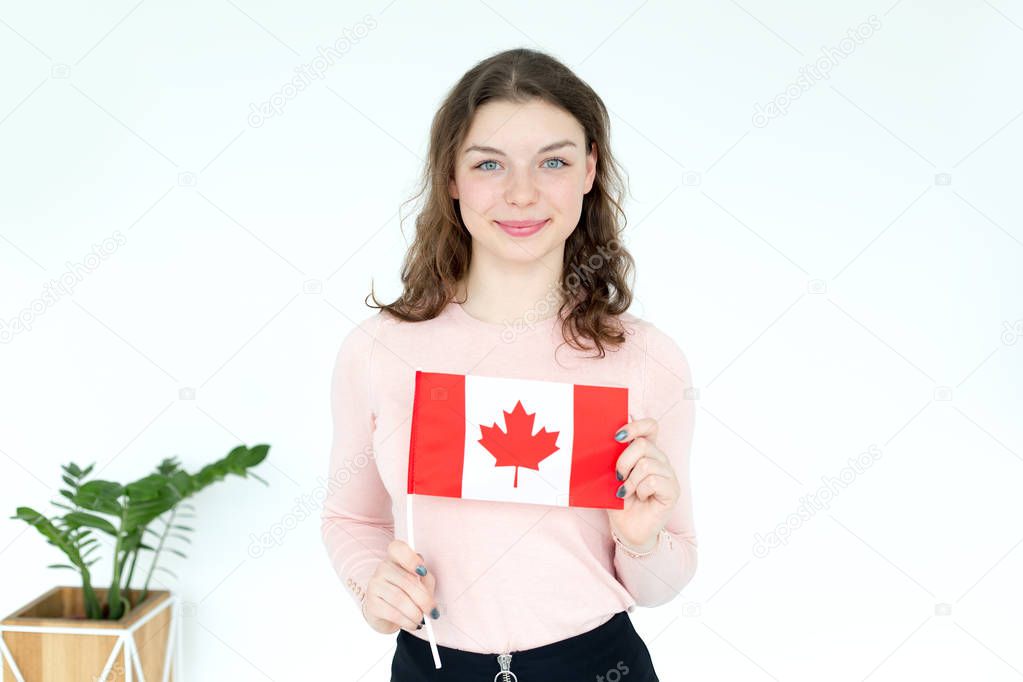 Young girl student with the flag of Canada in hands.