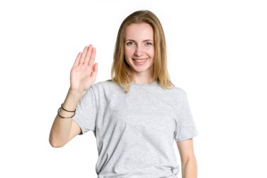 Merhaba. Genç kadın, hafif bir arka plan üzerinde izole içinde ileri, yukarı doğru bir palmiye elini kaldırdı. Karşılama jest.