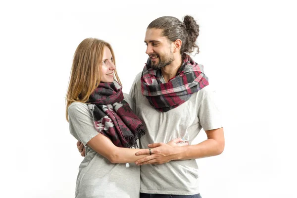 Young couple in love in shirts and scarves standing on a light background. Man and woman.
