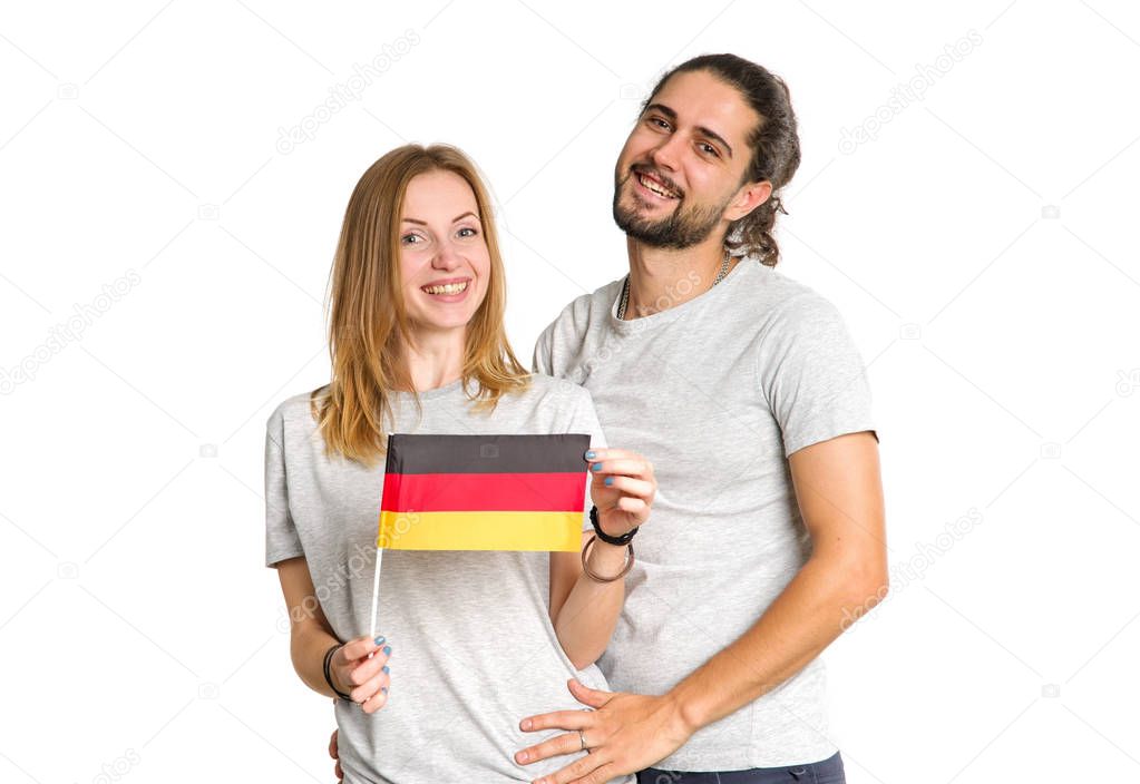Young couple, man and woman, with flag of Germany isolated on white background.