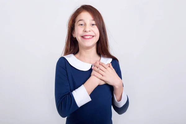 Happy Girl Holds Hands Chest Standing Light Background Joyful Schoolgirl — Stock Photo, Image