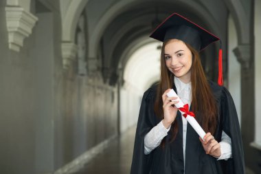 Happy young woman on her graduation day at the University. Education and people. clipart