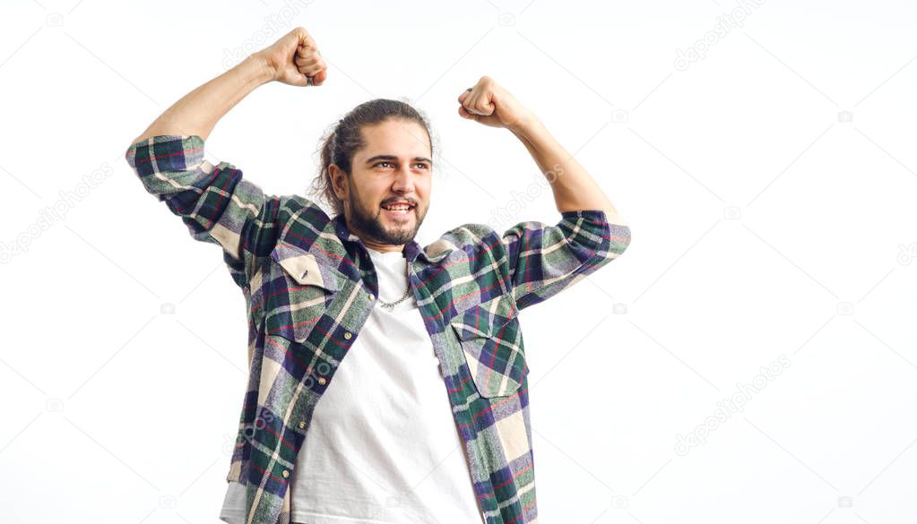 Winner, champion, football fan. Bearded happy man raised his arms above his head while standing on a white background.