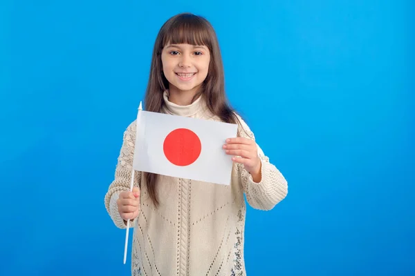 Little girl with the flag of Japan. Education abroad, Learn Japanese.