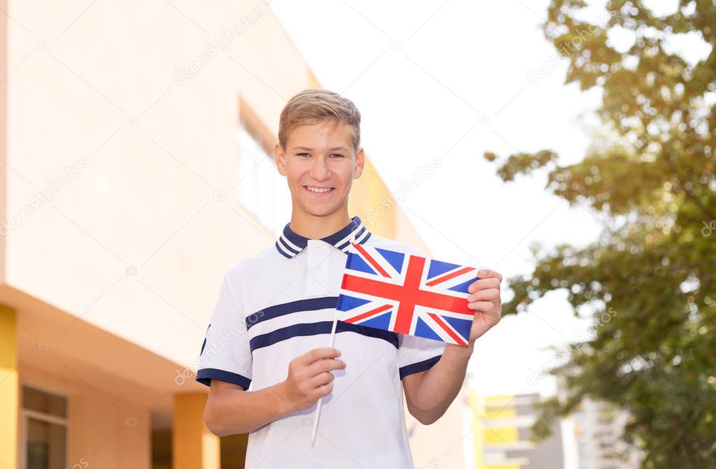 Teenager schoolboy with the flag of Great Britain. Study abroad.