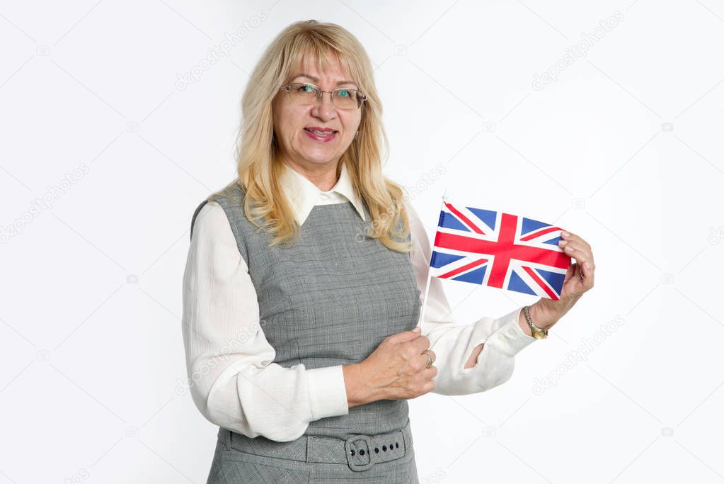 Mature woman with flag of Great Britain on bright background.
