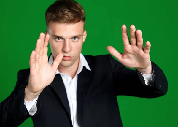 Man Holds His Hands Front Him Suit Green Background Protect — Stock Photo, Image