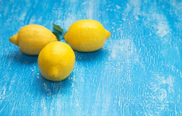 Tres Limones Sobre Fondo Madera Azul —  Fotos de Stock