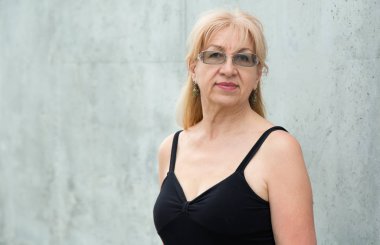 Gözlüklü mutlu olgun kadın, 55-60 yaşında.