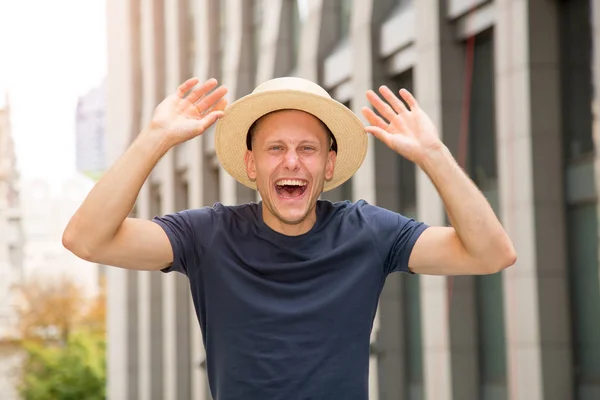 Greeting Young Happy Man Hat Raised His Hands Background European — Stock Photo, Image