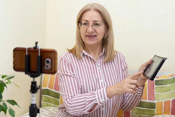 Mature Woman Conducts Online Training Looking Smartphone Showing Digital Tablet — Stock Photo, Image