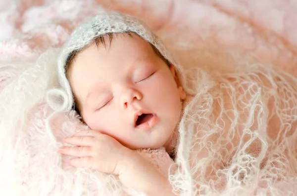 ニットウェアの柔らかいふわふわの敷物の上に寝ている生まれたばかりの赤ちゃん — ストック写真