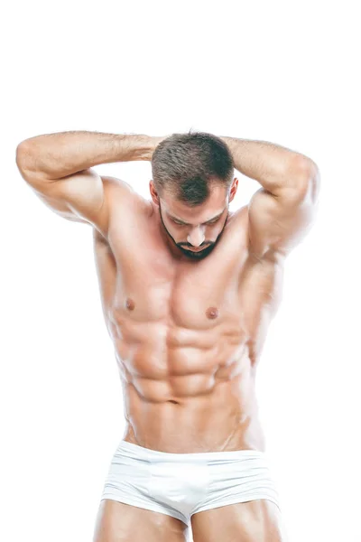 Bodybuilder posing. Beautiful sporty guy male power. Fitness muscled manin white lingerie. on isolated white background. — Stock Photo, Image