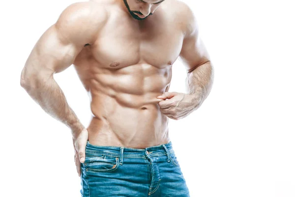 Bodybuilder posing. Beautiful sporty guy male power. Fitness muscled in blue jeans. on isolated white background. Measurement of fat. Drains the skin. Thin. — Stock Photo, Image