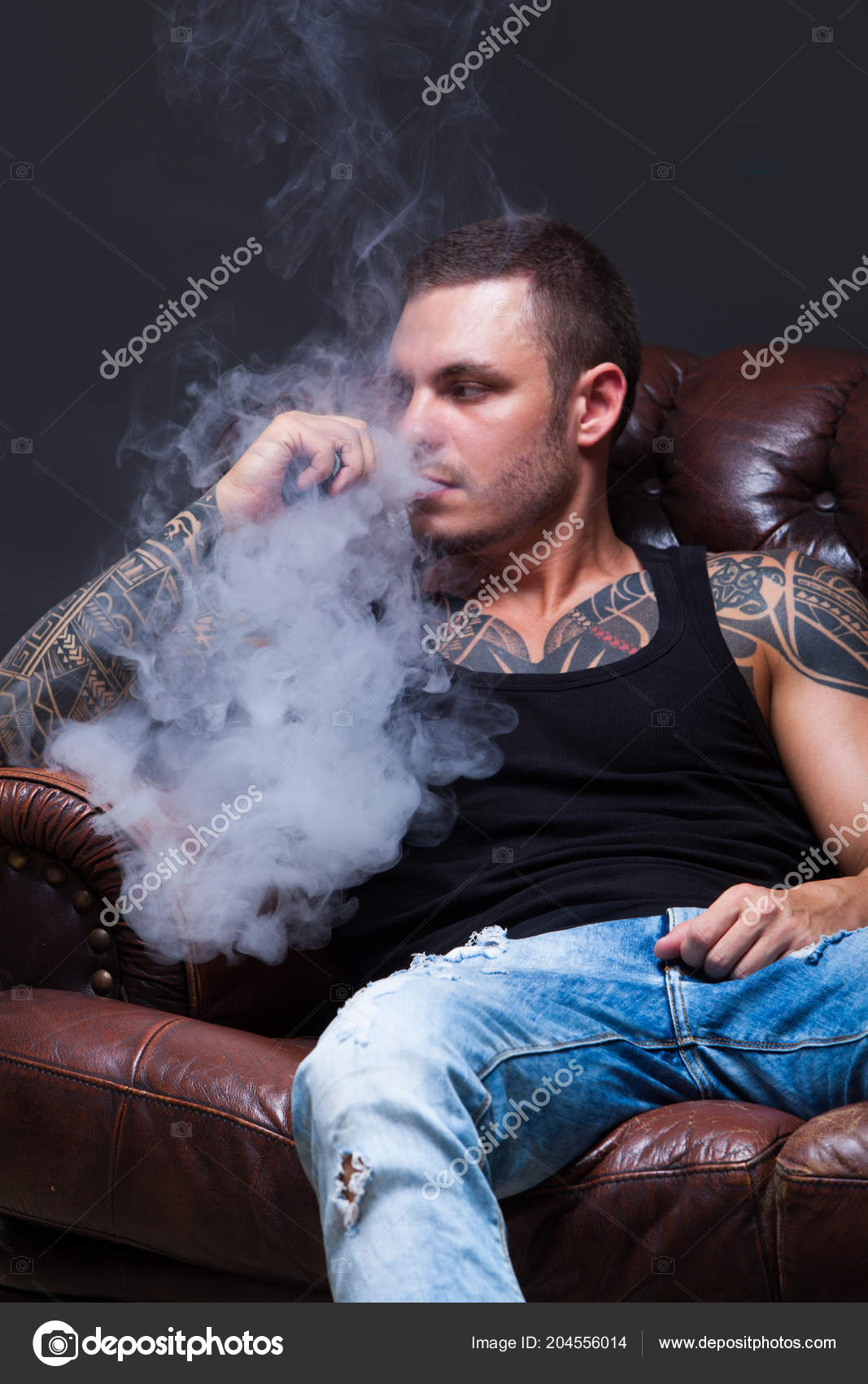 Vaper The Man With Sits On A Leather Sofa Smoke An