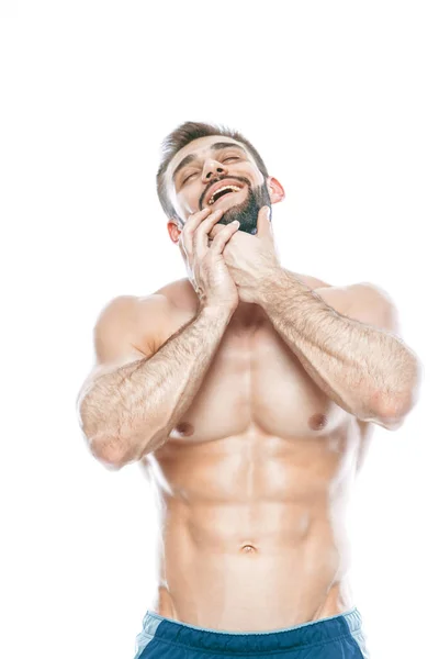 He stroked and touched his beard. A beautiful beard. Beautiful sporty guy male power. Fitness muscled in blue shorts. on isolated white background. — Stock Photo, Image