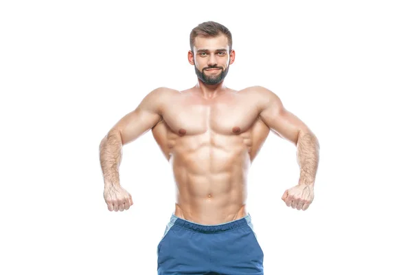 Kroppsbyggare poserar. Vacker sportig kille manlig makt. Konditionen muskulös i blå shorts. på isolerade vit bakgrund. Man med muskulösa överkropp. Stark atletisk Man Fitness modell Torso visar sex-pack abs — Stockfoto