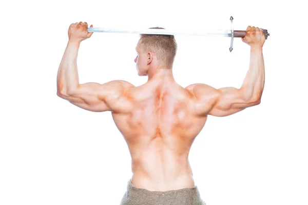 Bodybuilder man posing with a sword isolated on white background. Serious shirtless man demonstrating his mascular body. sword for head — Stock Photo, Image