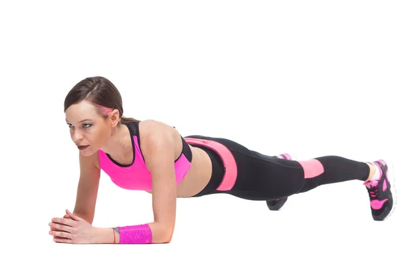 Een vrouw uitoefening workout fitness aërobe oefening op studio geïsoleerd witte achtergrond. Perfecte plank. — Stockfoto