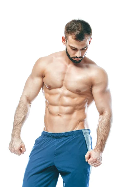 Bodybuilder posing. Beautiful sporty guy male power. Fitness muscled in blue shorts. on isolated white background. Man with muscular torso. Strong Athletic Man Fitness Model Torso showing six pack abs — Stock Photo, Image